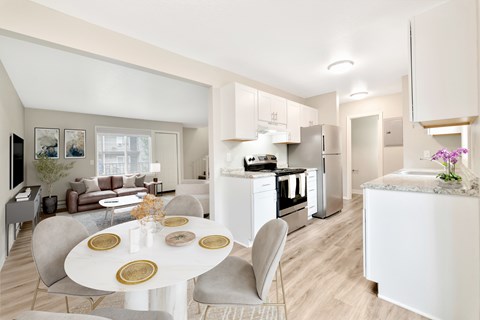 A modern kitchen with a dining table set for two.
