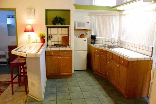 A kitchen with a white fridge at Salinas Sunset Apartments, California