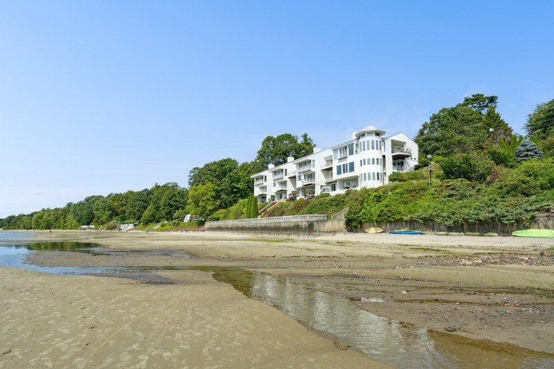 A beach with a building in the background.