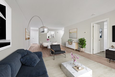 A living room with a grey couch and a white coffee table.