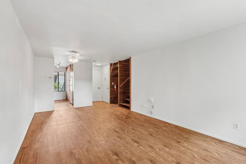 A room with wooden floors and white walls.