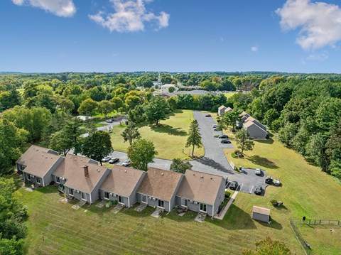 A bird's eye view of a residential area with buildings and cars.