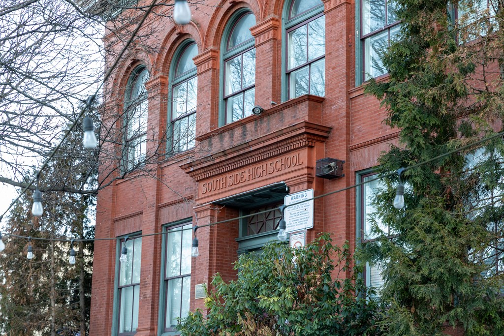 a large brick building with a sign in front of it