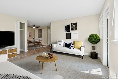 A living room with a white couch and a coffee table.