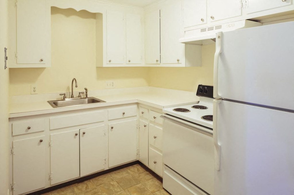 a kitchen with white appliances and white cabinets