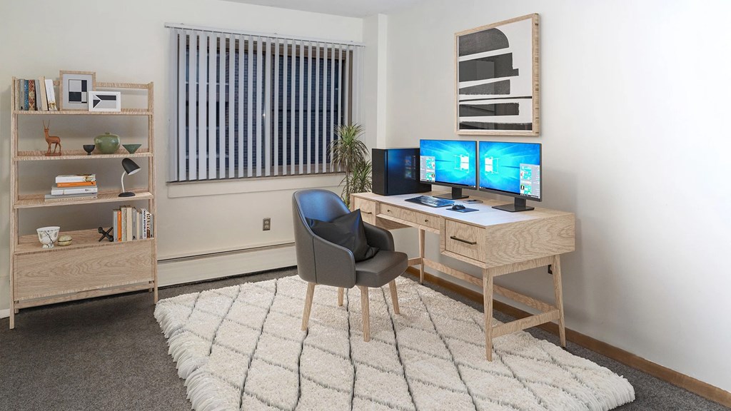 A room with a desk, chair, and bookshelf.