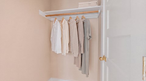 Clothes hanging on a clothes rack.