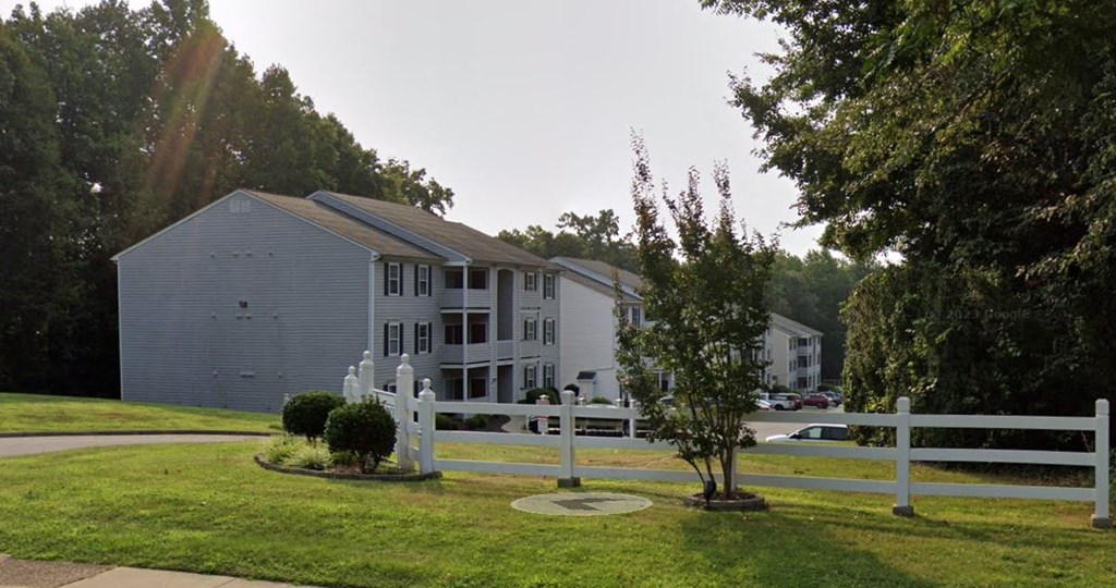 a white fence in front of a building at Woodgate, Charlottesville, 22901