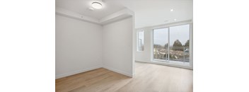 A room with a window overlooking a residential area.