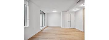 A room with wooden floors and white walls.