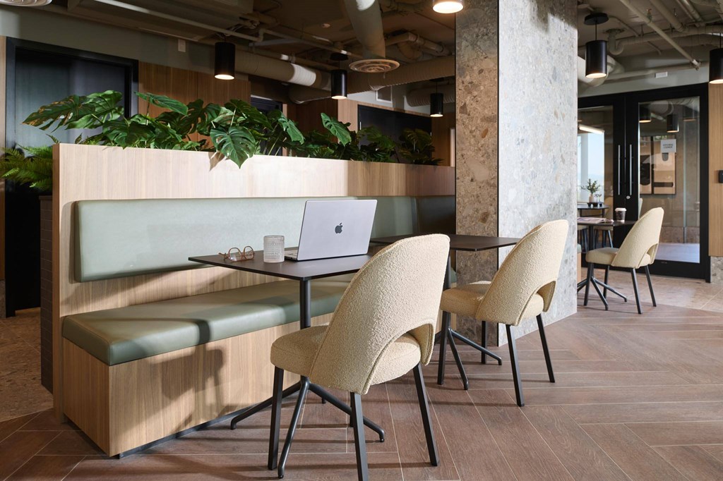 A modern office space with a wooden table and chairs.
