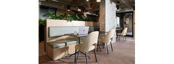 A modern office space with a wooden table and chairs.