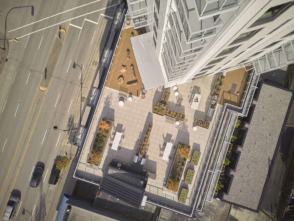 A view of a city street from above with cars and buildings.