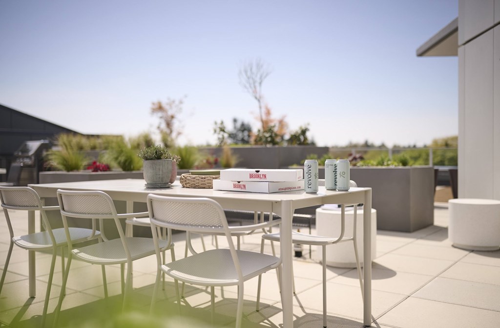 A white table and chairs are set up on a patio.