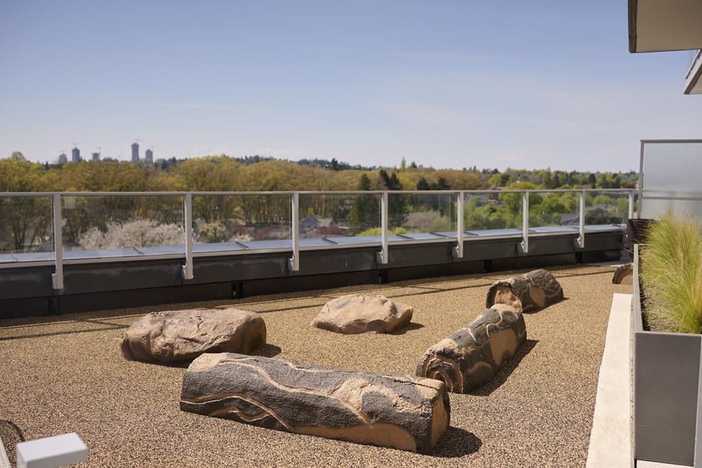 A balcony with a railing and a view of a city skyline.