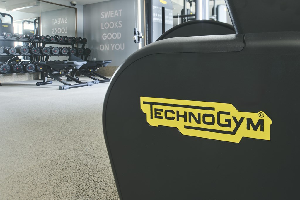 A close up of a black Technogym machine in a gym.