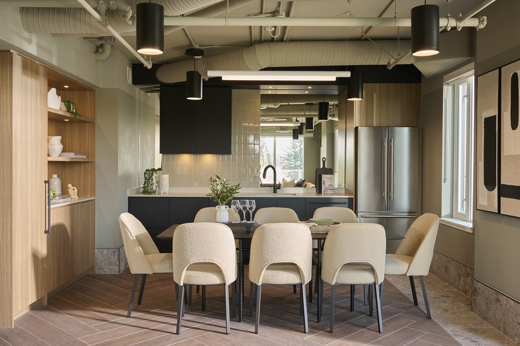 A modern dining room with a long table and chairs.