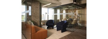 A modern office space with glass walls and a mix of blue and orange furniture.