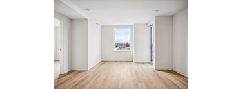 A room with wooden floors and white walls.