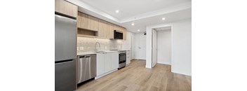 A modern kitchen with wooden cabinets and stainless steel appliances.