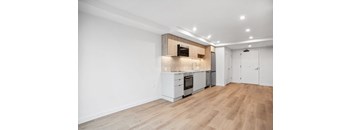 A kitchen with white cabinets and a wooden island.
