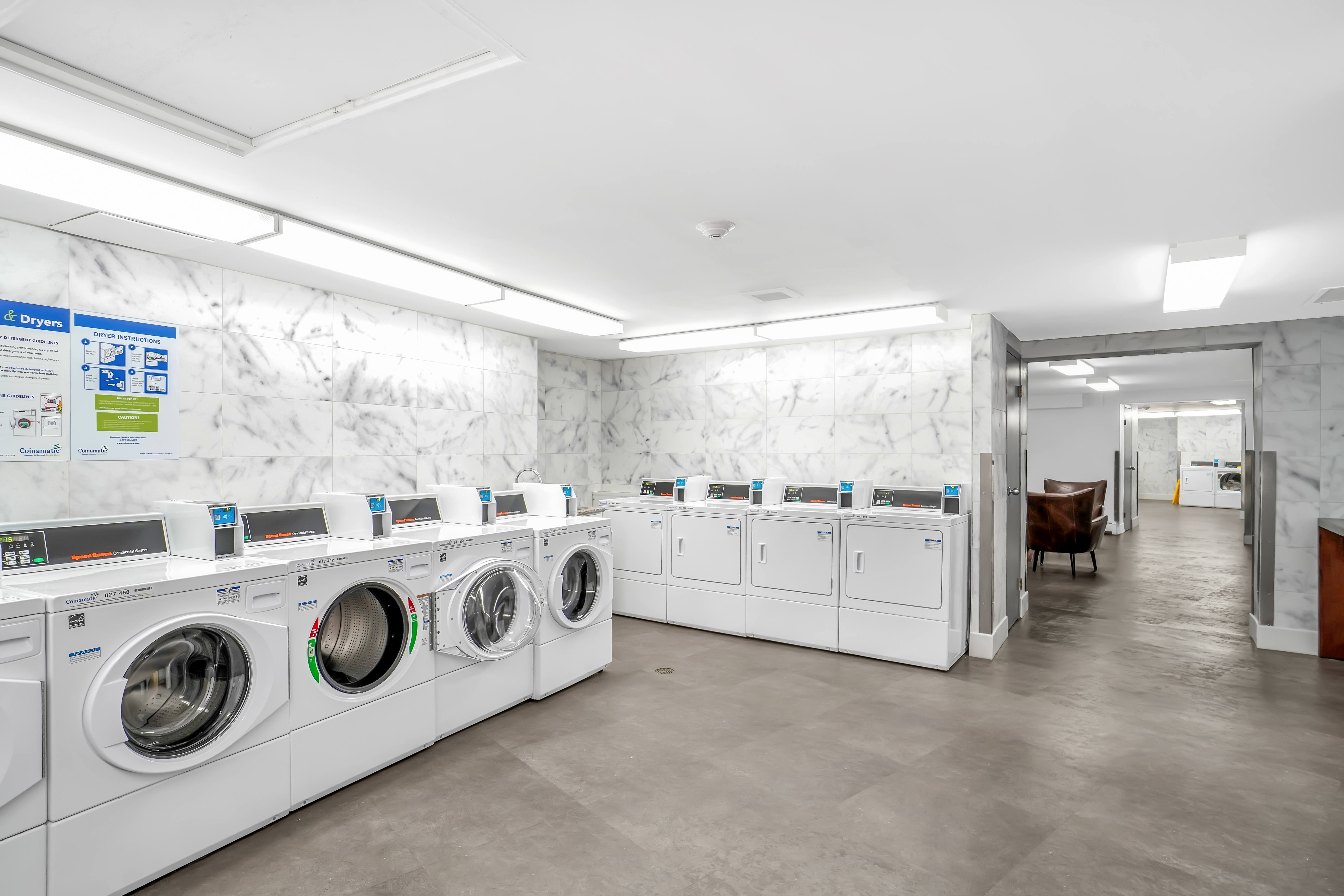 A row of washing machines in a laundromat.