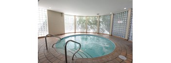 A round indoor pool with a glass wall surrounding it.