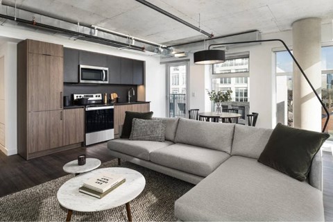 A modern living room with a grey sofa and a coffee table.