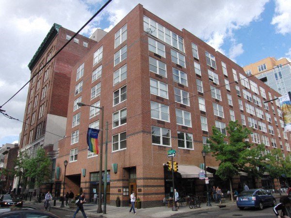 a large brick building on the corner of a city street