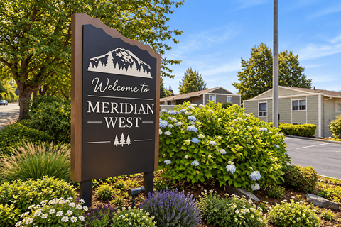 A brown sign with the words "Welcome to MERIDIAN WEST" on it.