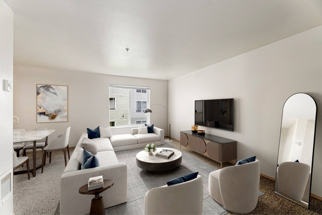 A modern living room with a white couch, a coffee table, and a television.