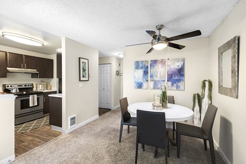 A dining room with a white table and chairs.