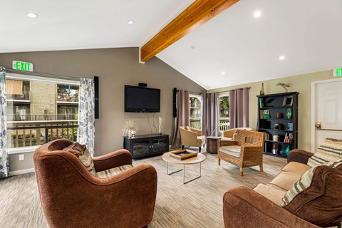 A living room with a brown chair and a brown couch.