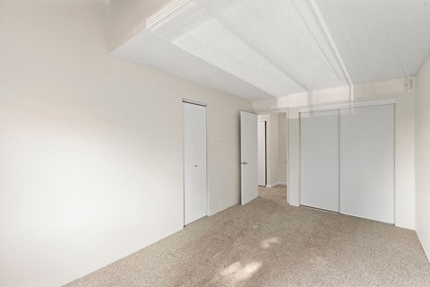 A white room with carpeted floor and white walls.