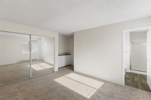 A room with a carpeted floor and a glass door.