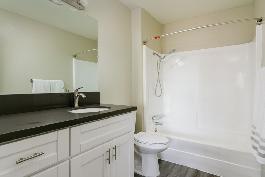 A white toilet sits next to a sink in a bathroom.