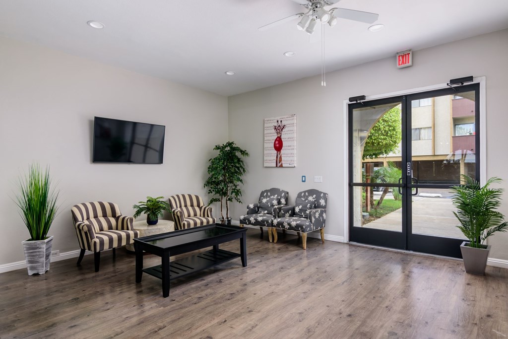 A living room with a black table and striped chairs.