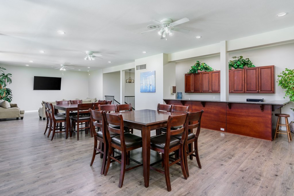 A dining room with a long table and chairs.