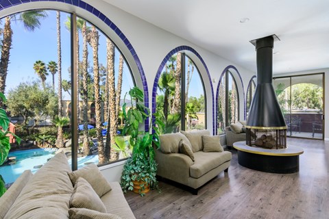 A living room with a large couch and a fireplace.