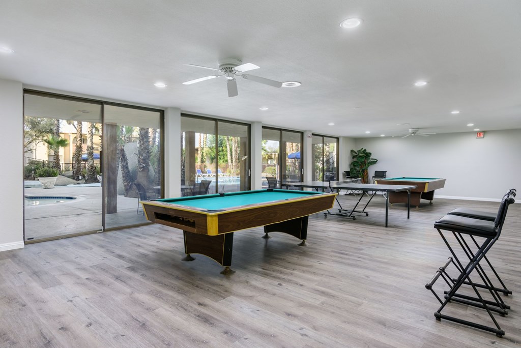 A room with a pool table and a chair.