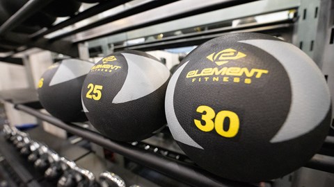 a close up of three dumbbells on a rack at Wynnwood Vinings Atlanta fitness center