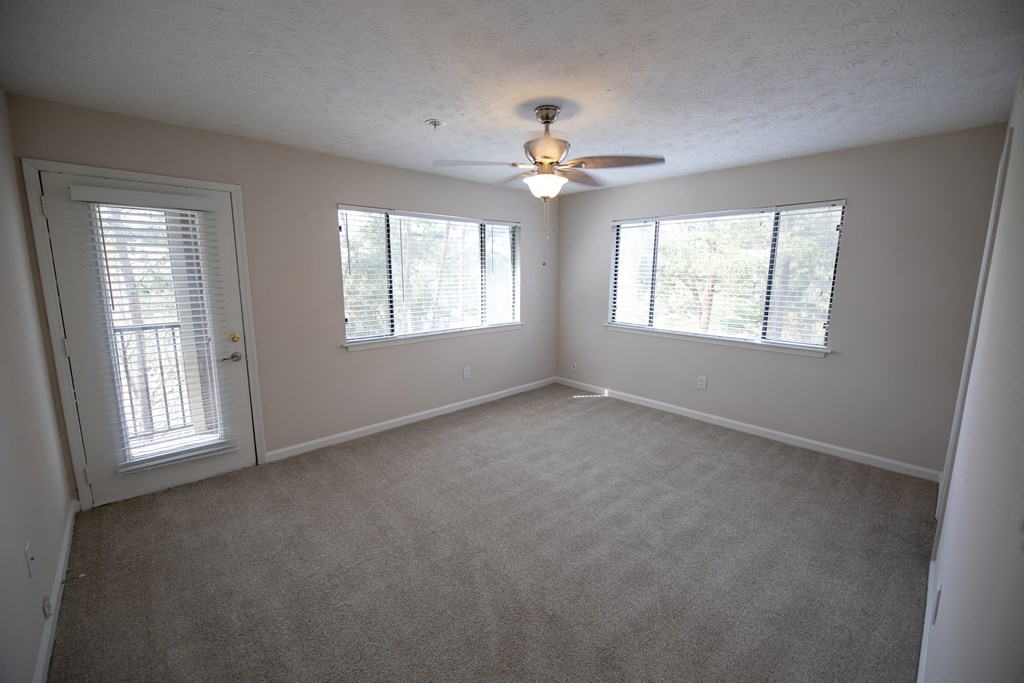 Carpeted bedroom with a ceiling fan at Wynnwood Vinings Atlanta