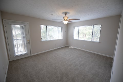 Carpeted bedroom with a ceiling fan at Wynnwood Vinings Atlanta