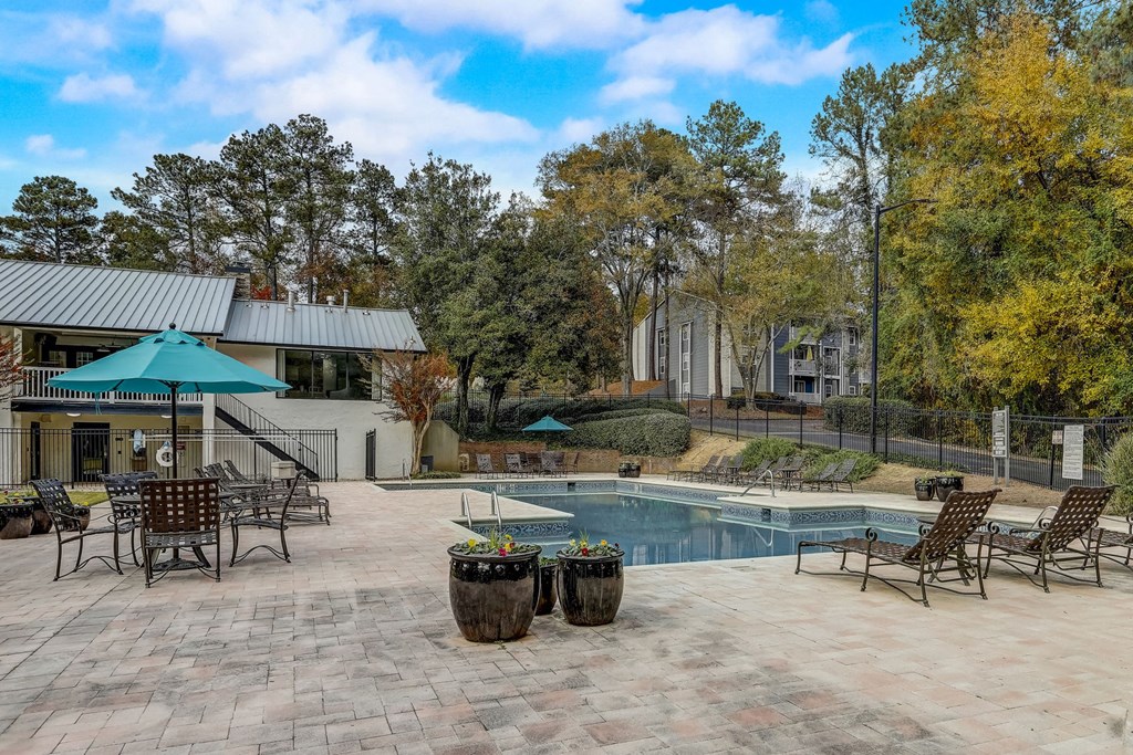 the outdoor poolside lounge area with chairs at Veridian at Sandy Springs