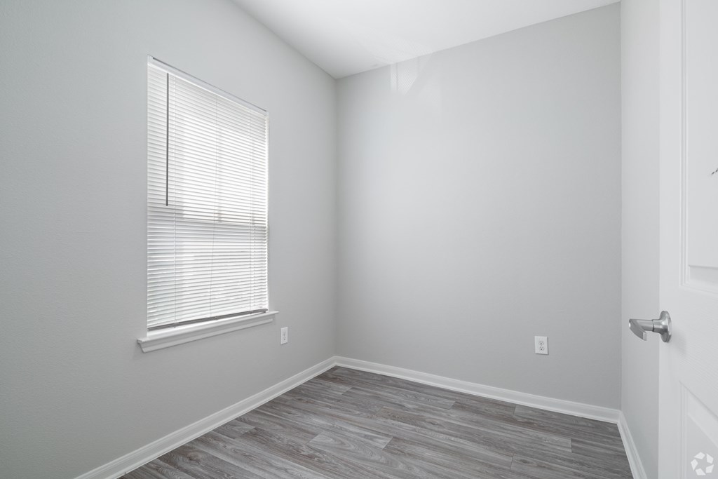 A room with a window and a door.