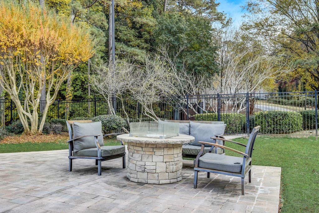 a patio with chairs and a fire pit at Veridian at Sandy Springs