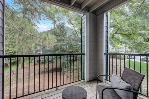 a private balcony with a view of a yard and trees at Wynnwood Vinings Atlanta