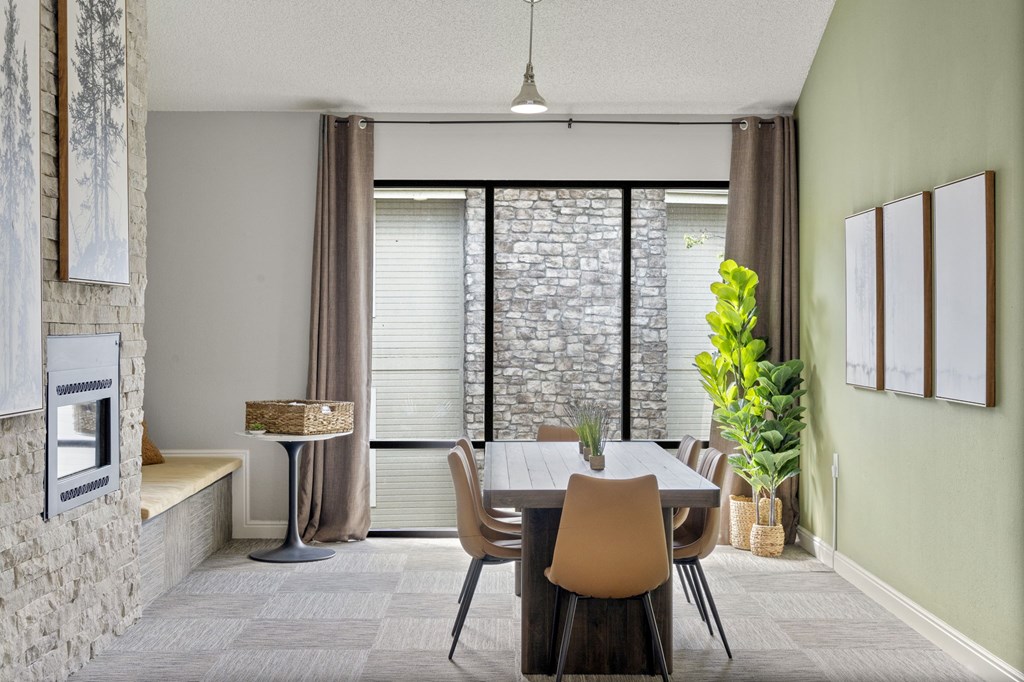 A dining room with a table and chairs.