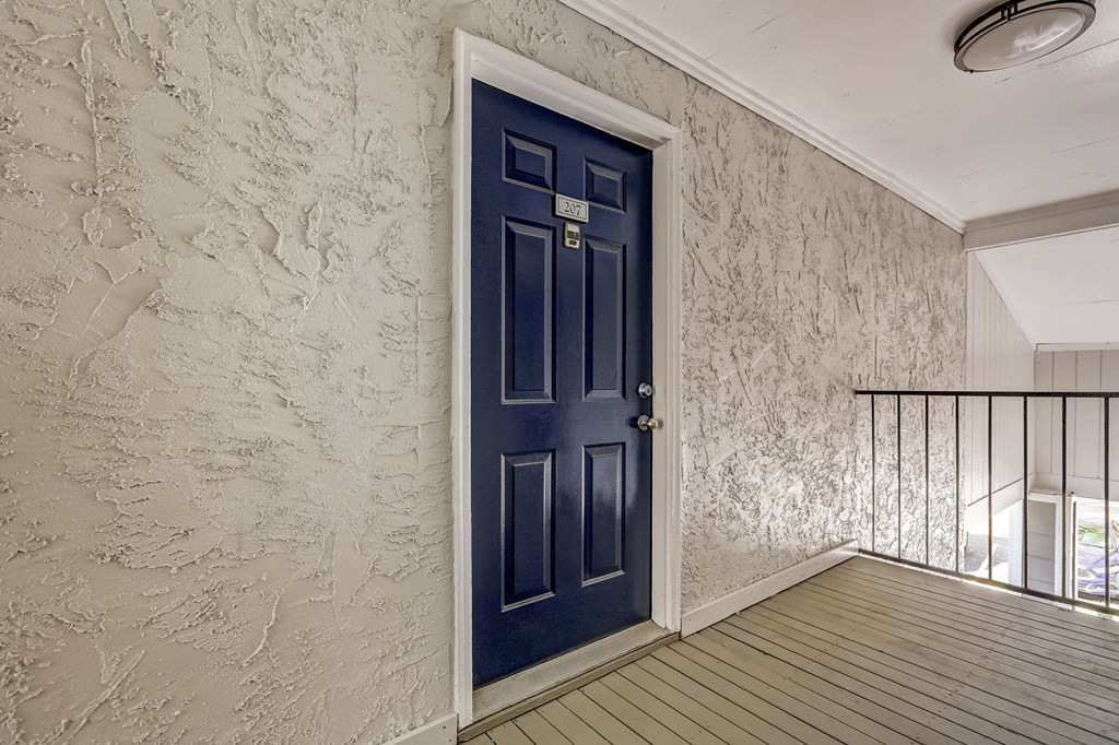 the front door painted blue of an apartment home at Veridian at Sandy Springs
