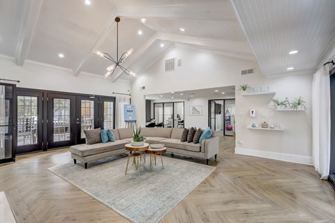 A spacious living room with a large sofa and a coffee table.